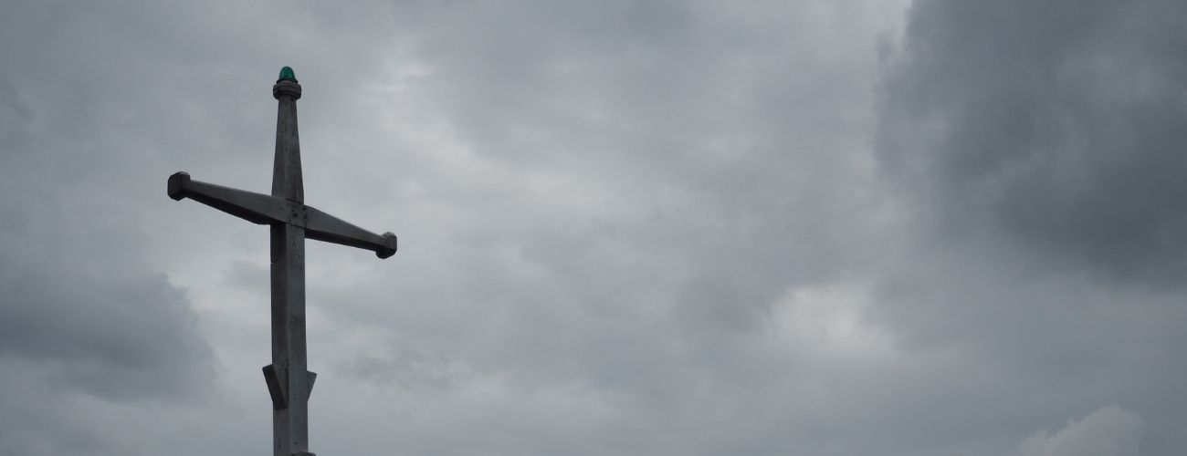 cross with dark colored sky in background