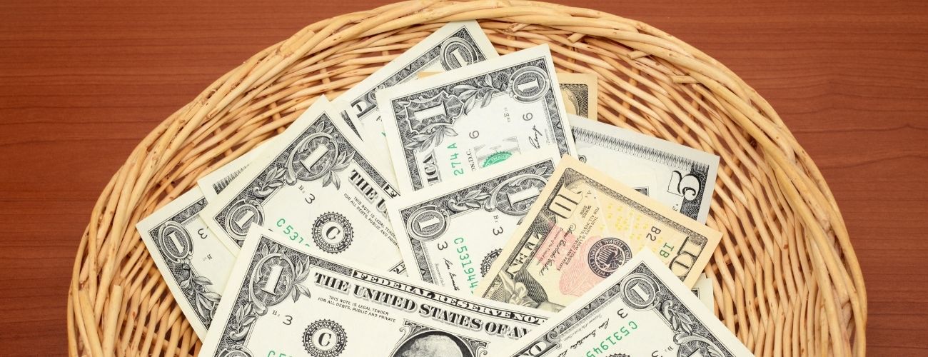 money in a church offering basket